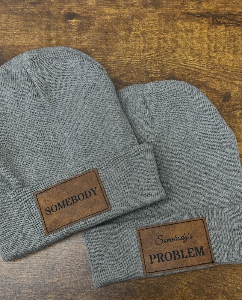 Matching grey beanies with leather patches engraved 'Somebody' and 'Somebody's Problem'