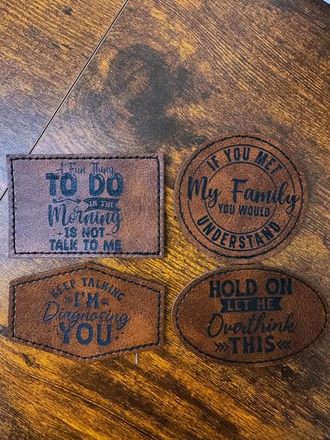 Four engraved leather patches with funny sayings