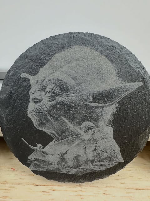 Detailed character portrait engraved on round slate